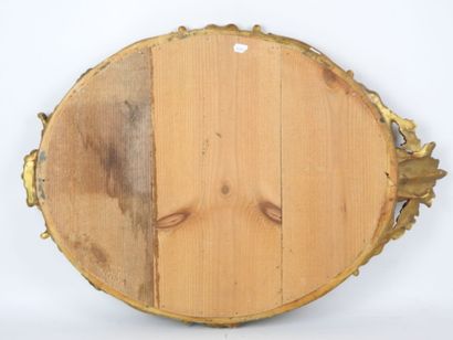 Carved wood and gilded stucco oval frame...
