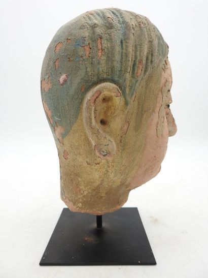 China. Earthenware man's head on a wooden...