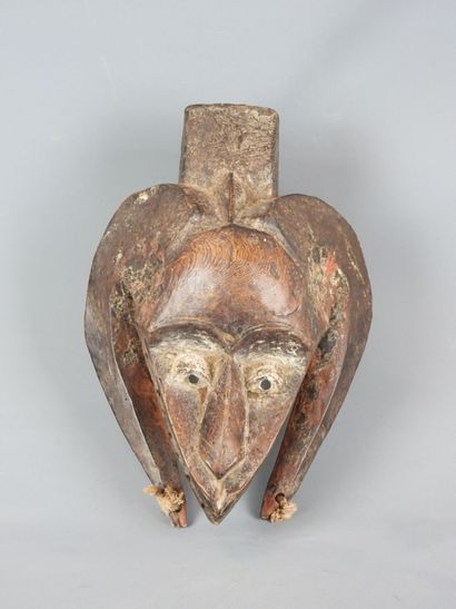 Dance mask with triangular face framed by...