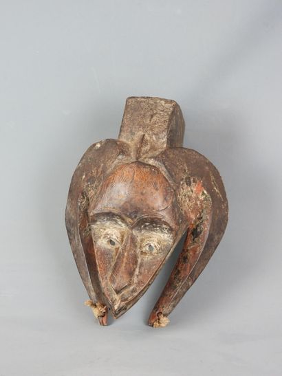 Dance mask with triangular face framed by...