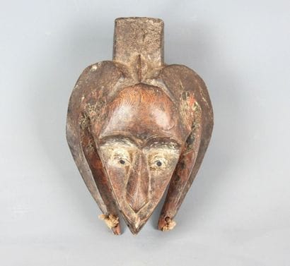 Dance mask with triangular face framed by...