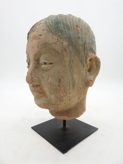 China. Earthenware man's head on a wooden...