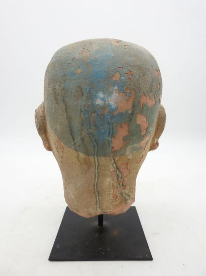 China. Earthenware man's head on a wooden...