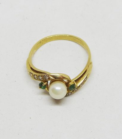 Gold ring set with a cultured pearl delicately...
