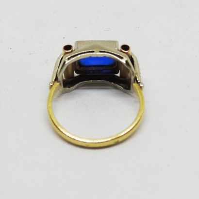 Gold-set ring with a central emerald-cut...