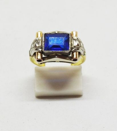 Gold-set ring with a central emerald-cut...