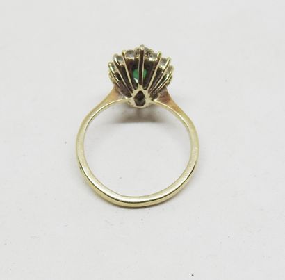Gold-set marquise ring with a central emerald...