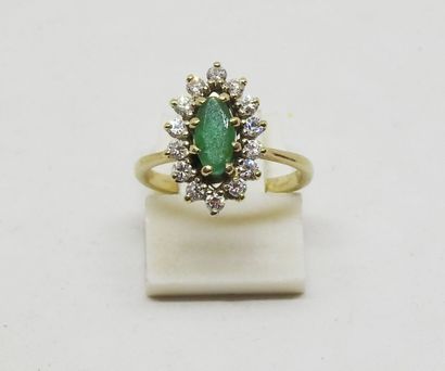 Gold-set marquise ring with a central emerald...
