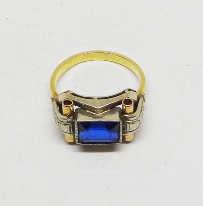 Gold-set ring with a central emerald-cut...