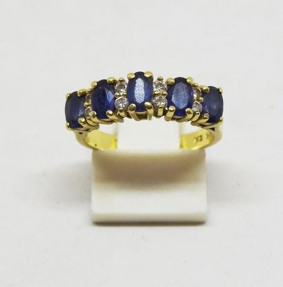 18K gold ring set with five blue stones alternating...