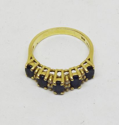18K gold ring set with five blue stones alternating...