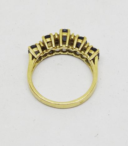 18K gold ring set with five blue stones alternating...