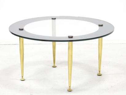 LOW TABLE with circular glass top resting...