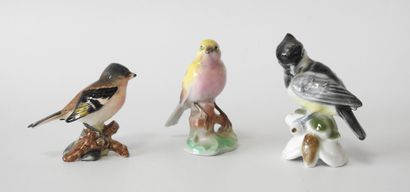 Lot of three polychrome porcelain birds including:...