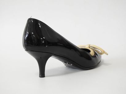 PRADA
Black patent leather pumps with cream...