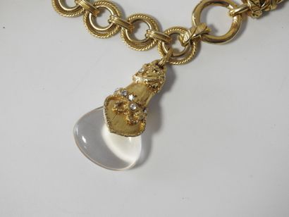 A large piece of costume jewelry, with gilded...