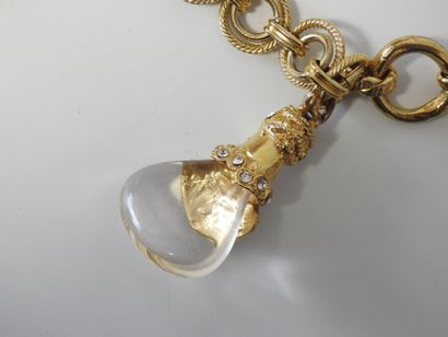 A large piece of costume jewelry, with gilded...