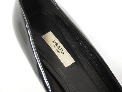 PRADA
Black patent leather pumps with cream...