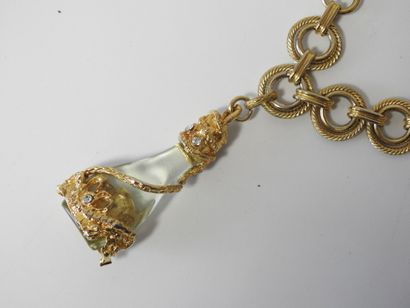 A large piece of costume jewelry, with gilded...