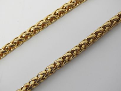 A large piece of costume jewelry, with gilded...