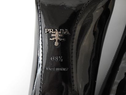 PRADA
Black patent leather pumps with cream...