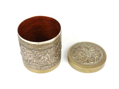 Cylindrical silver box decorated with a floral...