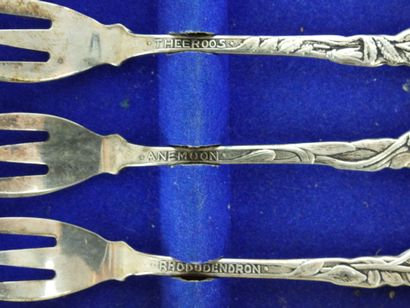 Six SMALL silver FORKS with flower design....