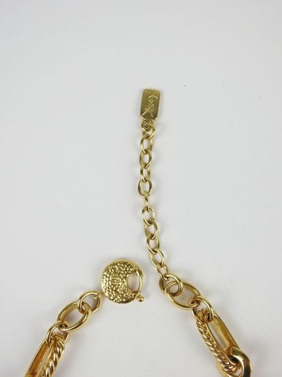 YVES SAINT LAURENT - Paris. Gold-plated metal...