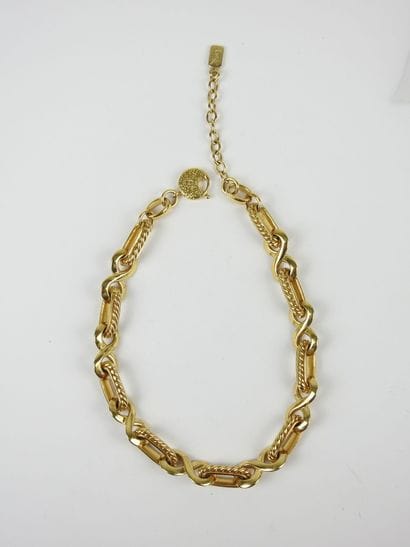 YVES SAINT LAURENT - Paris. Gold-plated metal...