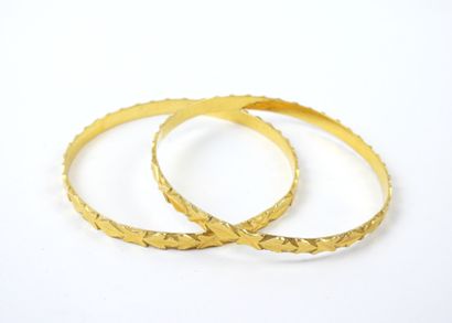 Deux BRACELETS JONCS en or 750/1000°. Travail...