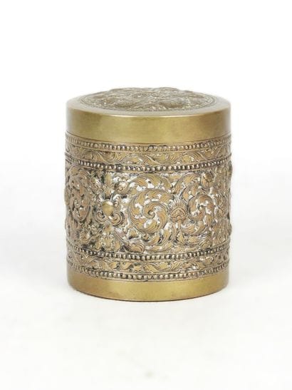 Cylindrical silver box decorated with a floral...