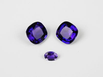 THREE AMETHYSTS on paper, two cushion-cut...