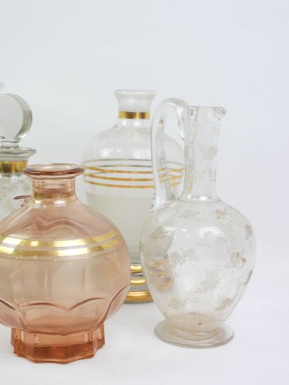 Four liqueur bottles and a glass and crystal...