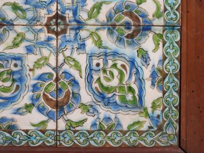 Four Iznik-style earthenware tiles with floral...