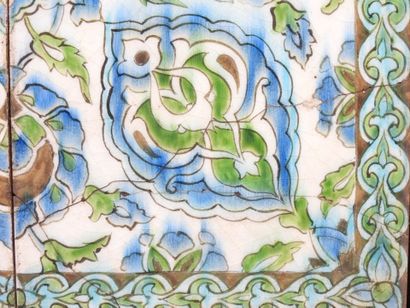 Four Iznik-style earthenware tiles with floral...