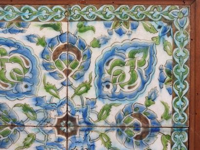 Four Iznik-style earthenware tiles with floral...