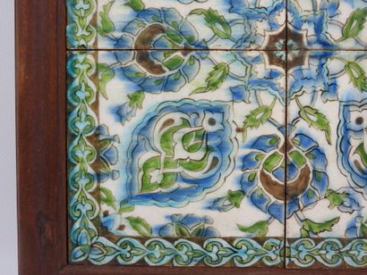 Four Iznik-style earthenware tiles with floral...