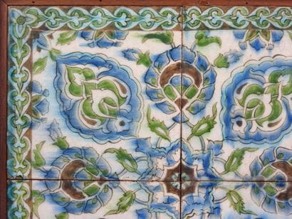 Four Iznik-style earthenware tiles with floral...