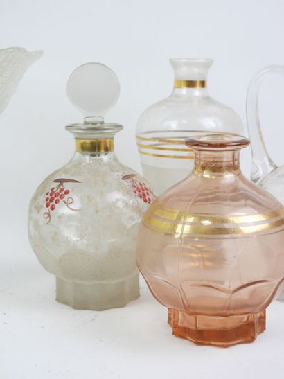 Four liqueur bottles and a glass and crystal...