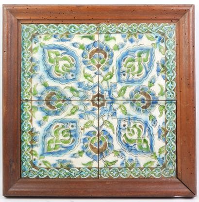 Four Iznik-style earthenware tiles with floral...