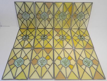 Suite de douze vitraux ornés d'un motif végétal,...