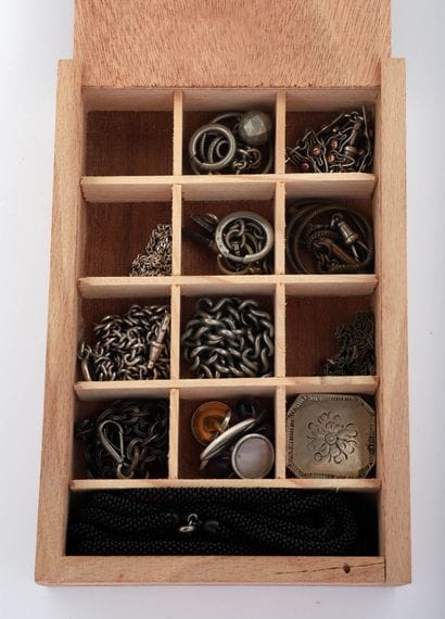 Box with compartments containing nine metal...