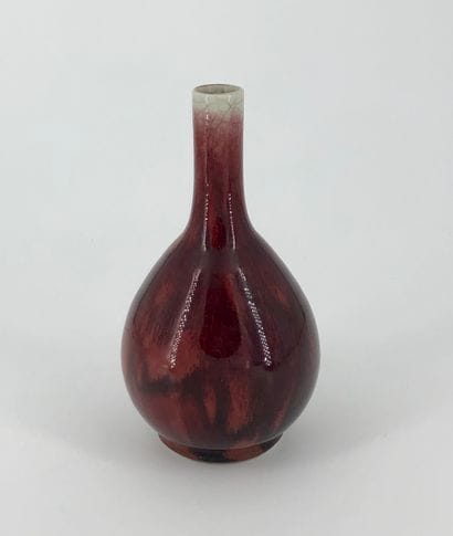 A long-necked porcelain vase enamelled with...
