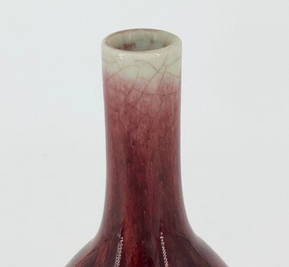 A long-necked porcelain vase enamelled with...