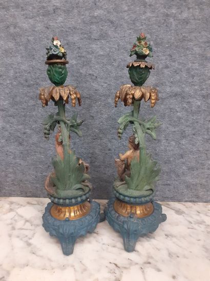 Deux candélabres à décor de putti en métal...