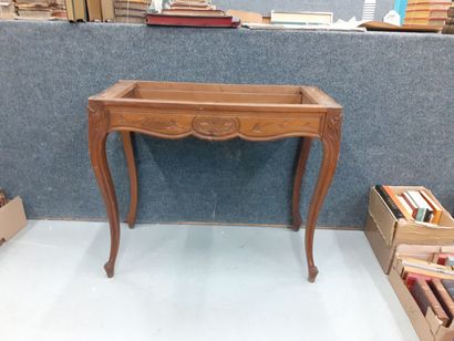 Console en bois naturel à décor de feuillages...