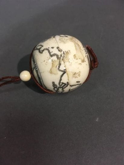 Pendentif en os gravé, globe terrestre 
Diam :...