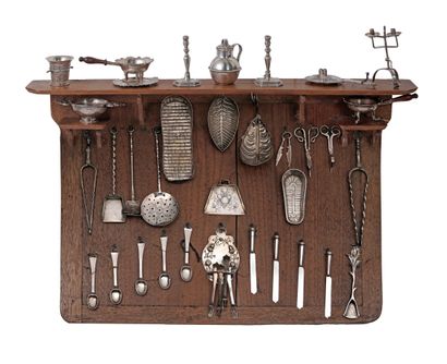 Amusing silver dinette, presented on a wooden...