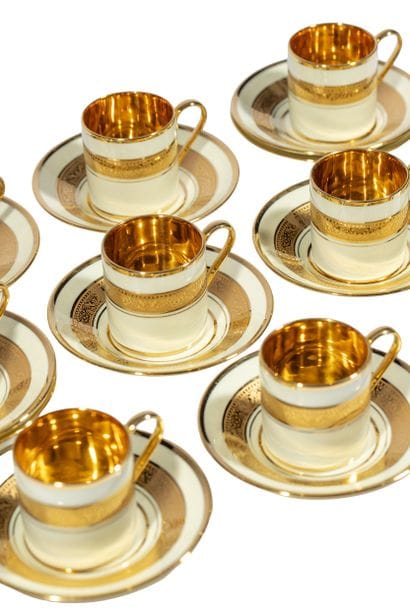 Ten porcelain cups and twelve saucers decorated...