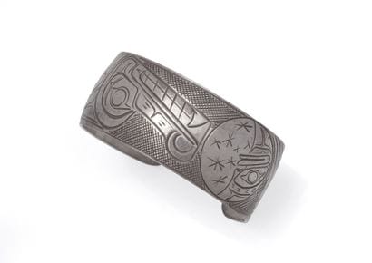 Open silver bracelet featuring a wolf and...